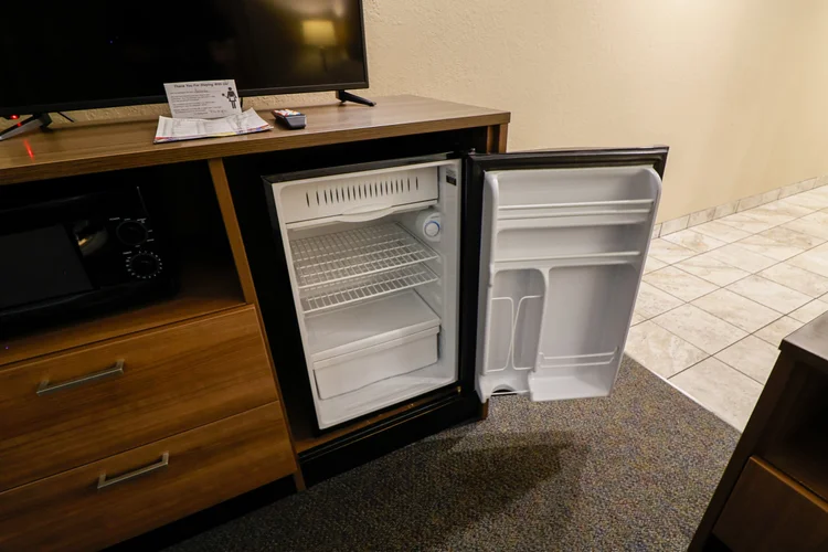 Norma Dan Motel King Room with Fireplace and/or Jacuzzi dresser with TV, microwave, and mini fridge