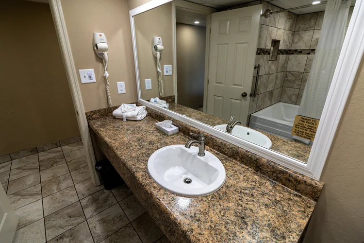 Norma Dan Motel King Room with Fireplace and/or Jacuzzi bathroom sink and mirror