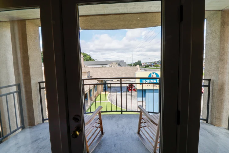 Norma Dan Motel King Room with Fireplace and/or Jacuzzi balcony view with rocking chairs