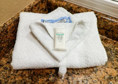 Norma Dan Motel washrag, towel and toiletries in bathroom