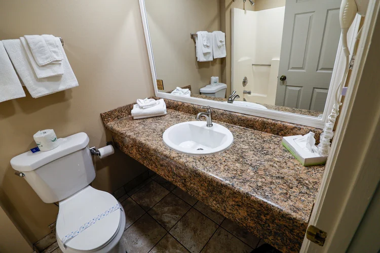 Norma Dan Motel Two Queen Bed Room bathroom sink and toilet